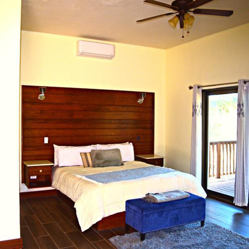 a bedroom with a large bed with a wooden headboard at Omni Sancti Hotel Boutique & Polo Club in Francisco Zarco