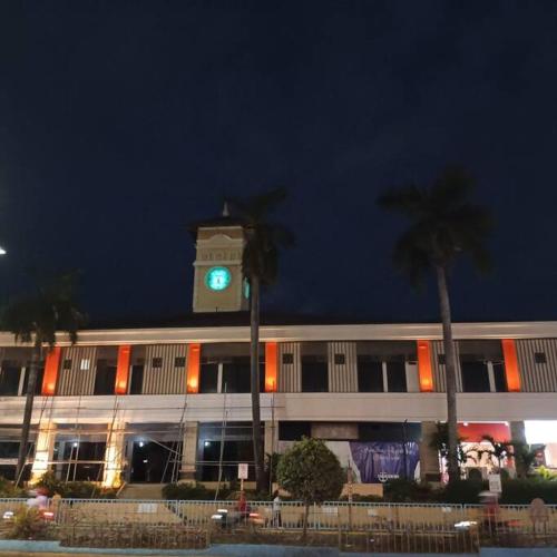 a building with a clock tower in front of a building at The Nearest Studio from MactanAirport with Disney+ in Pusok