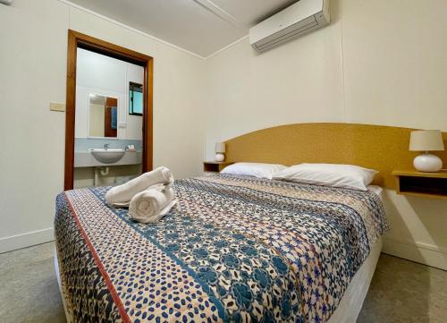 a bedroom with a bed with a towel on it at Big4 Port Douglas, Glengarry Holiday Park in Port Douglas