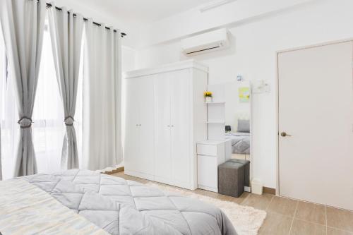 a white bedroom with a bed and a closet at Sofea Suites @ Troika Kota Bharu #Wifi #Netflix in Kota Bharu