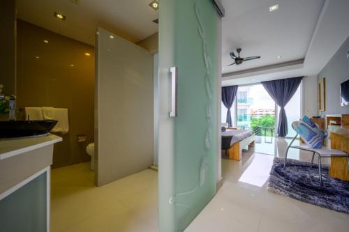 een badkamer met een toilet en een slaapkamer bij Cozy Resort, A Boutique Hotel in Pattaya South