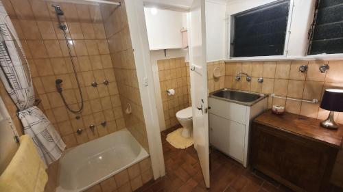 a bathroom with a sink and a shower and a toilet at Adorabe 1-Bedroom guesthouse with free parking on premises in Melbourne