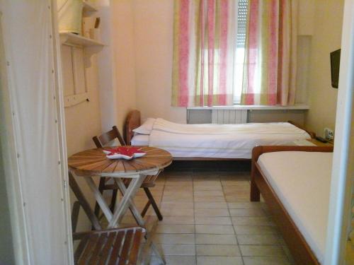 a small room with a small table and a bed at Guesthouse Lessi in Zagreb
