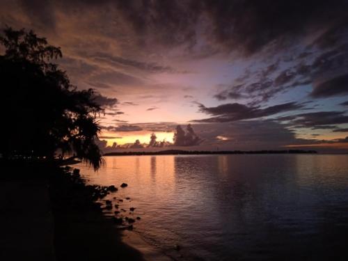 a sunset over a large body of water at Bintang Tiga Bungalows Gili Air in Gili Air