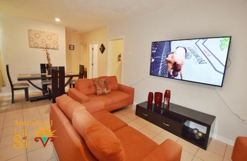 a living room with a couch and a flat screen tv at Villa Del Sol in Ixmiquilpan