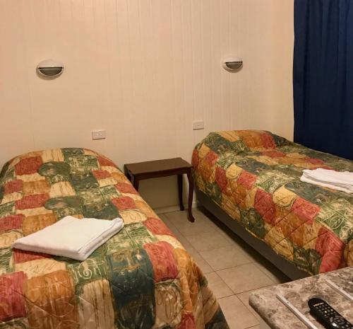 a room with two beds and a table at Big4 Port Douglas, Glengarry Holiday Park in Port Douglas
