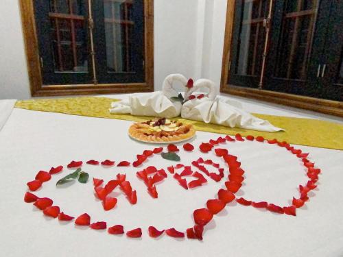 a valentines heart on a table with a pizza at Elephant Boutique Hotel in Luang Prabang