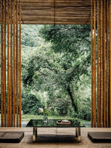 a room with a table in front of a large window at Commune by the Great Wall, in the Unbound Collection by Hyatt in Yanqing