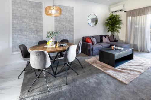 a living room with a table and a couch at Modern 3 bed overlooking Hagley Park in Christchurch