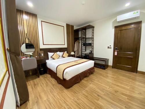 a hotel room with a bed and a table and a mirror at ĐTT Galaxy Tam Chúc in Ðục Khê