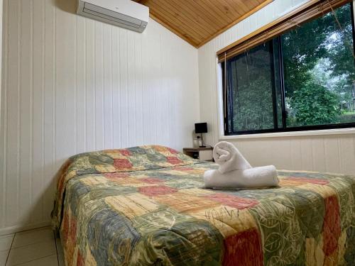 a bedroom with a bed with a towel animal on it at Big4 Port Douglas, Glengarry Holiday Park in Port Douglas