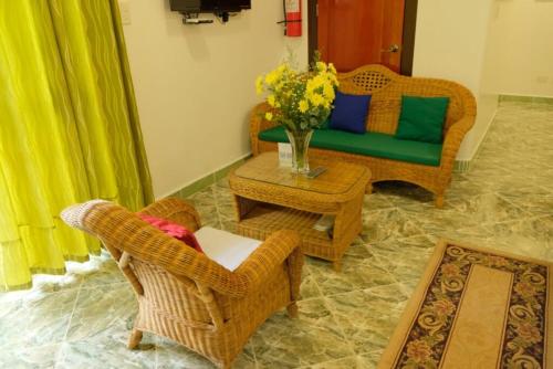a living room with a couch and chairs and a table at Villa Italia Hotel in Sorsogon