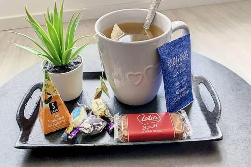 un vassoio con una tazza di caffè e caramelle di SUPER Studio Tout équipé WIFI 2PERS a Saint-Quentin