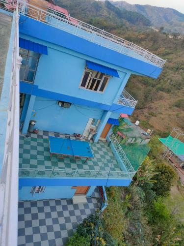 an aerial view of a house with a blue facade at Mahamaya Homestay 4 in Mandi