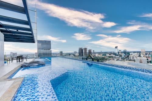 a swimming pool on the roof of a building at Luxcity Hotel & Apartment in Phnom Penh