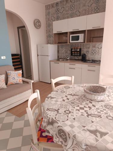 a kitchen and dining room with a table and chairs at oasi scala dei turchi in Realmonte