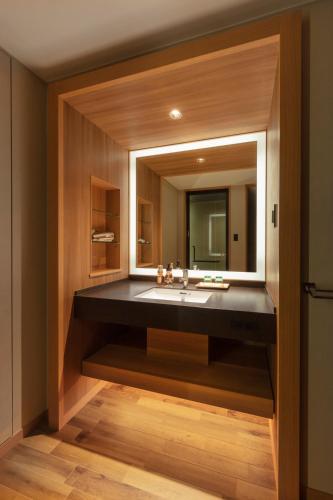 a bathroom with a sink and a mirror at Matsushima Ichinobo in Matsushima