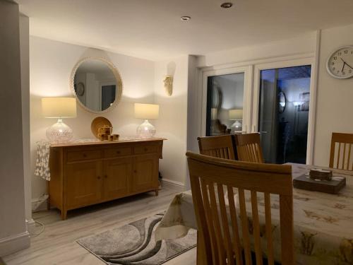 a bedroom with a table and a mirror on the wall at Historic Picturesque Apartment Pembroke in Pembrokeshire