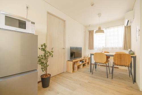 a kitchen and dining room with a table and chairs at 自由自在OSU 301(KAZE) in Nagoya