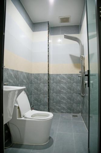 a bathroom with a toilet and a glass shower at Hoa Hướng Dương Hotel in Phan Rang