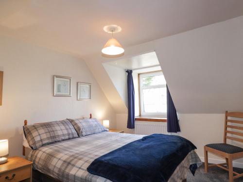 a bedroom with a bed and a window at Alt na Voir in Tomintoul