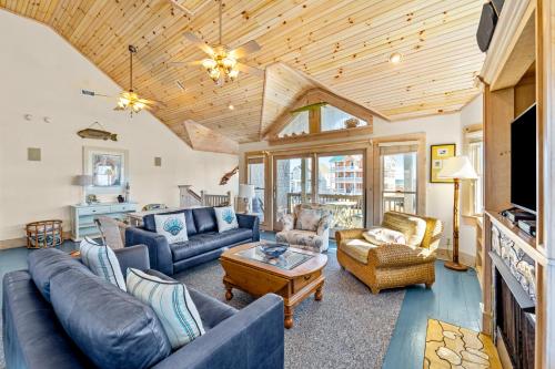 a living room with couches and a tv at Hatteras Memories in Hatteras