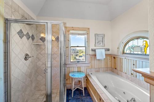 a bathroom with a tub and a glass shower at Hatteras Memories in Hatteras