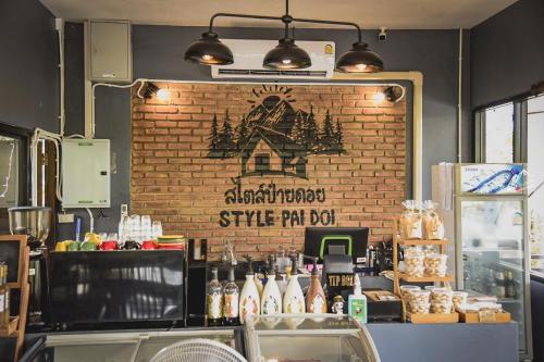 a brick wall with a sign on it in a bakery at Style Paidoi Resort in Ban Pa Yang (3)