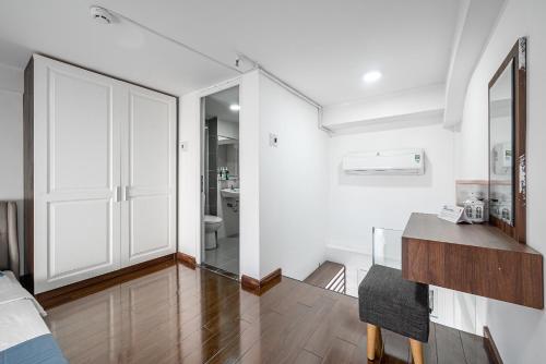 a white room with a table and a mirror at Cozrum Homes - Sonata Residence in Ho Chi Minh City