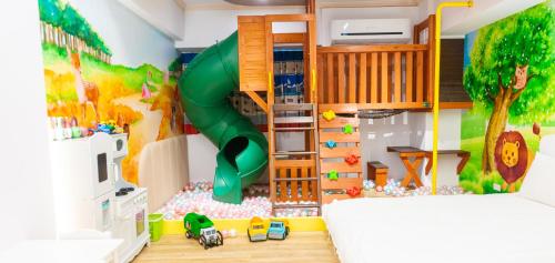 a bedroom with a play room with a slide at 寶貝樂溜滑梯親子民宿 in Luodong