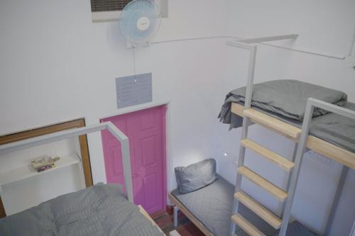 a dorm room with a bunk bed and a ladder at Rahee Bi Roambay - Backpacker Hostel in Mysore