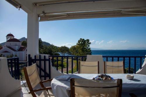 a table on a balcony with a view of the ocean at Perdika Sea Soul in Perdhika