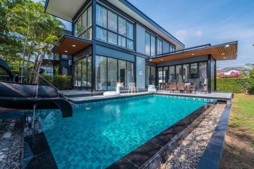 an exterior view of a house with a swimming pool at AnB Loft 1 poolvilla 3BR/3bath in Ban Huai Yai