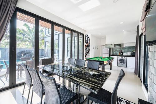 a dining room with a ping pong table and chairs at AnB Loft 1 poolvilla 3BR/3bath in Ban Huai Yai