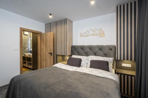 a bedroom with a large bed in a room at Chalet Pod Brdom - Apartments in Ružomberok
