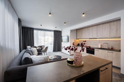 a living room and kitchen with a couch and a table at Chalet Pod Brdom - Apartments in Ružomberok