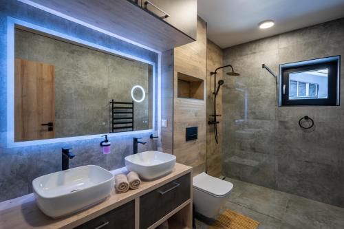 a bathroom with two sinks and a shower at Chalet Pod Brdom - Apartments in Ružomberok