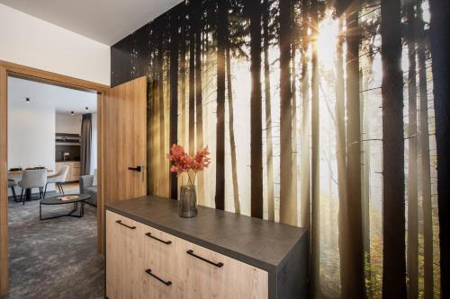 a room with a wall mural of trees at Chalet Pod Brdom - Apartments in Ružomberok