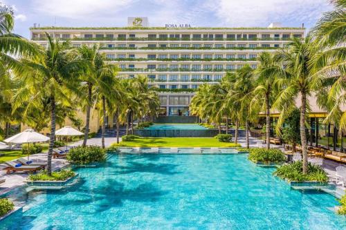 a hotel with palm trees and a pool at KHÁCH SẠN PHÚ YÊN - Khách sạn ven biển - trung tâm Tuy Hoà in Tuy Hoa