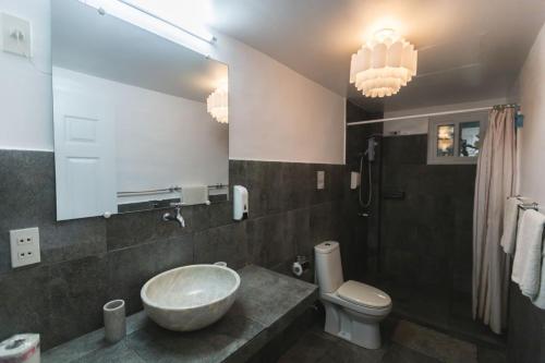 a bathroom with a bowl sink and a toilet at The Three P Beach Resort & Dive Center in Romblon