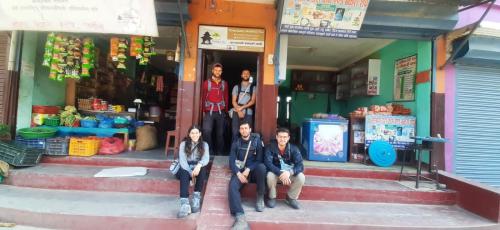 a group of people sitting on steps outside of a store at COMMUNITY HOLIDAY INN in Panauti