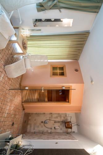 an attic bathroom with a toilet in a room at Hotel Alle Piramidi in Segonzano