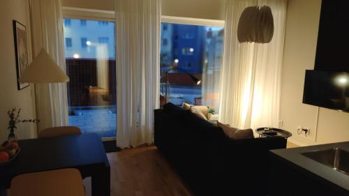 a living room with a couch and a large window at Studio Living in Karlskrona