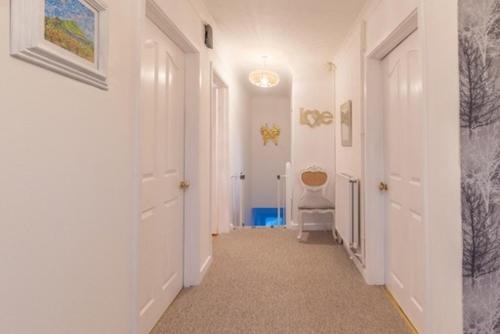 a hallway with a toilet in a room with white walls at Glastonbury, large House Stunning views 2 to 5 bedrooms, 3 receptions turn into bedrooms in Glastonbury