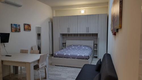 a bedroom with a bed and a table and a dining room at Savenaantico9 in Bologna