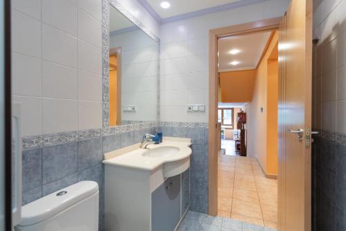 La salle de bains est pourvue d'un lavabo, de toilettes et d'un miroir. dans l'établissement Saturraran - baskeyrentals, à Mutriku