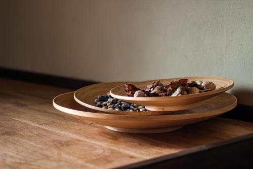 two wooden bowls on a table with rocks in them at Agriturismo Cardella in Piobbico