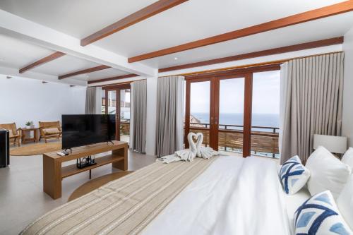 a living room with a television and a couch at The AVA Resort Koh Tao in Koh Tao