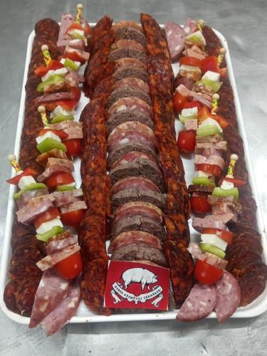 a tray of food with meat and vegetables on it at Vendégház a Csabay Kúriához in Lakitelek