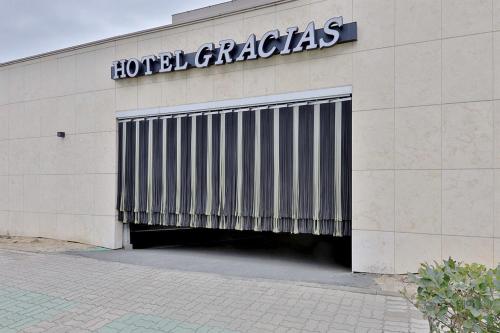 a building with a garage with a sign on it at Gracias Hotel Gimhae in Gimhae